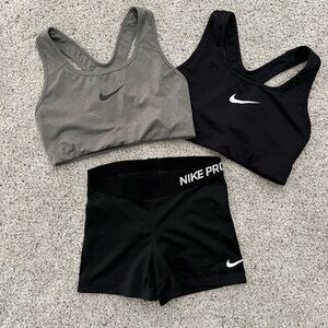 Two Nike sports bras and one pair of Nike spandex shorts